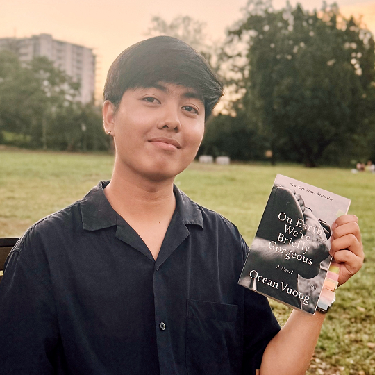 Aaron, holding his book recommendation, On Earth We’re Briefly Gorgeous