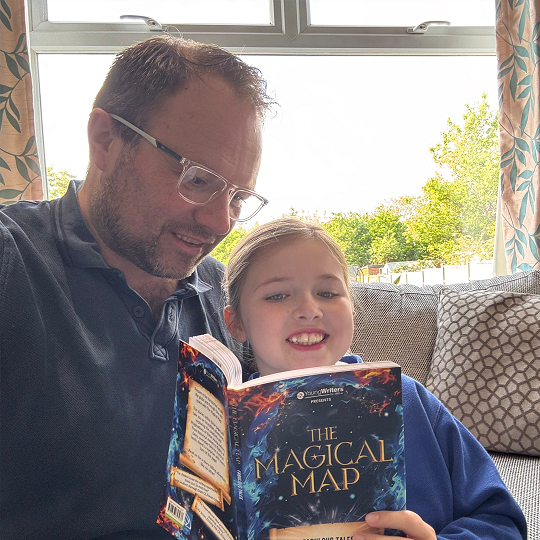 Grant, holding his book recommendation, The Magical Map