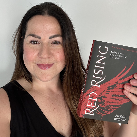 Laura, holding her book recommendation, Red Rising
