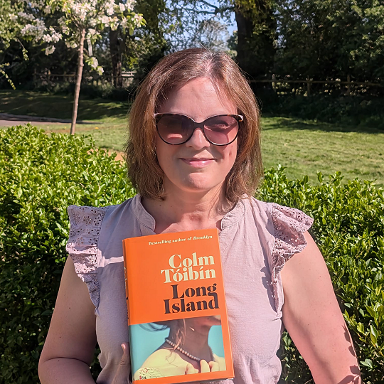 Lydia, holding her book recommendation, Long Island